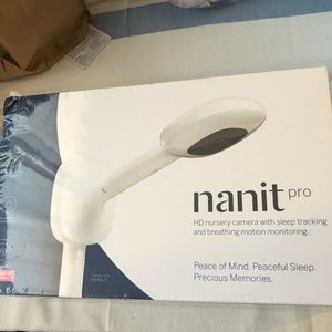 It’s a white camera it clips on crib or wall mounted and give a Birds Eye view